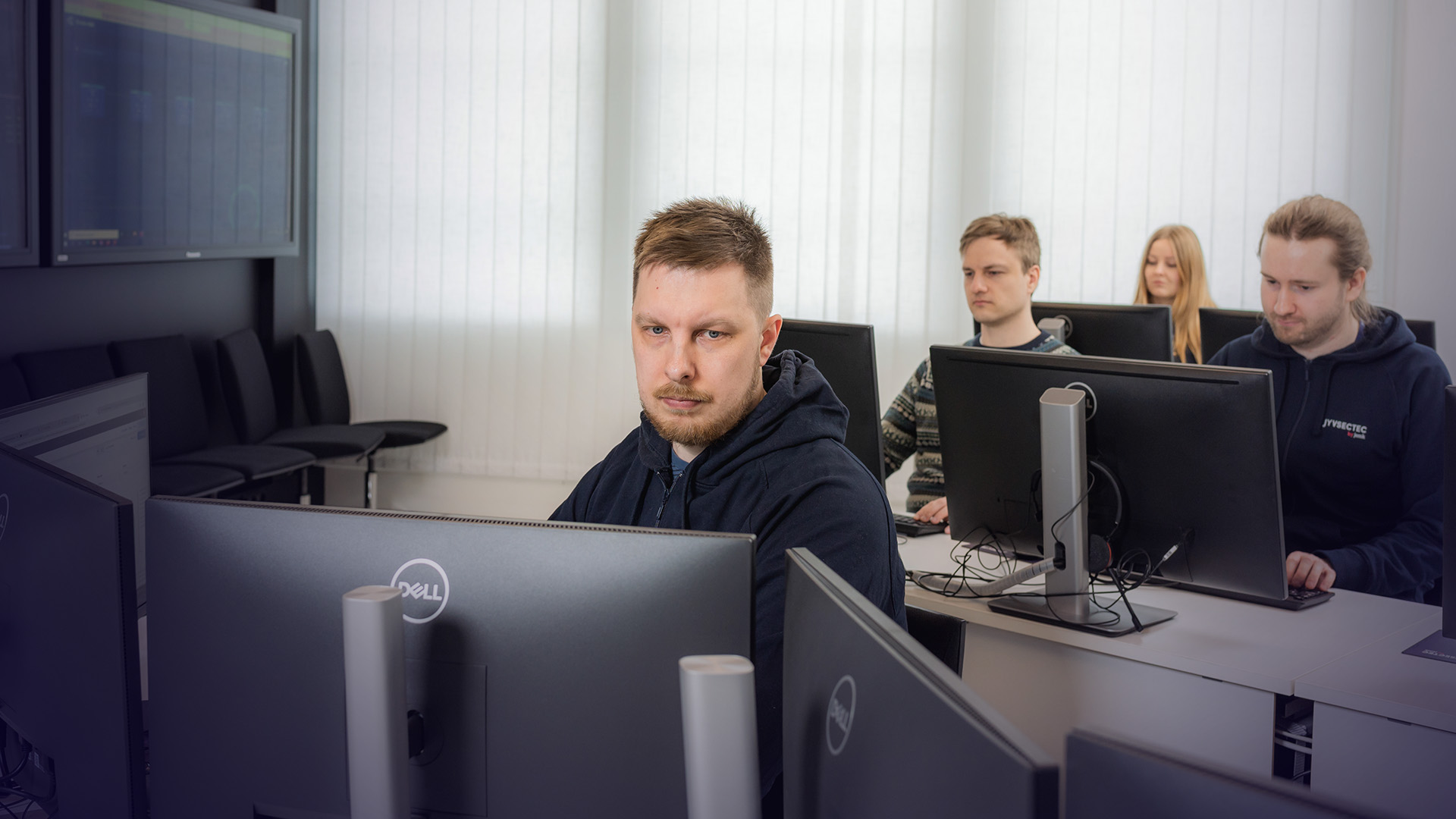 JYVSECTEC staff sitting on computer